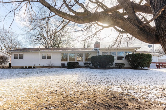 snow covered back of property with central air condition unit