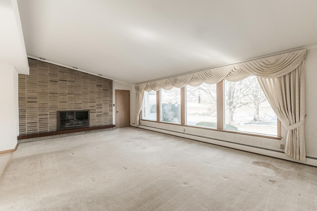 unfurnished living room with a tiled fireplace, a baseboard radiator, lofted ceiling, and carpet