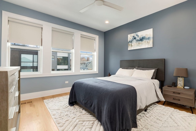 bedroom with ceiling fan and light hardwood / wood-style flooring