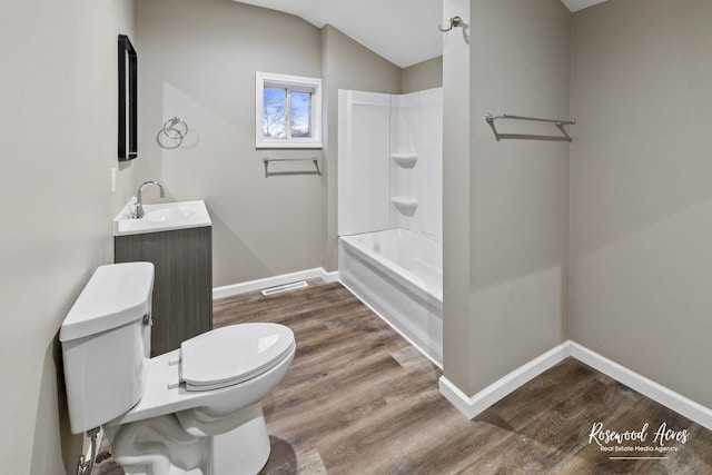 full bathroom featuring wood-type flooring, lofted ceiling, toilet, vanity, and bathtub / shower combination