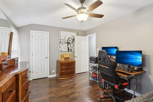 home office with ceiling fan, dark hardwood / wood-style flooring, and lofted ceiling