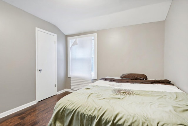 bedroom featuring dark hardwood / wood-style floors and lofted ceiling