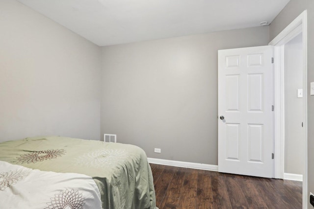 bedroom featuring dark wood-type flooring