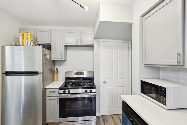 kitchen featuring decorative backsplash, light hardwood / wood-style floors, and stainless steel appliances