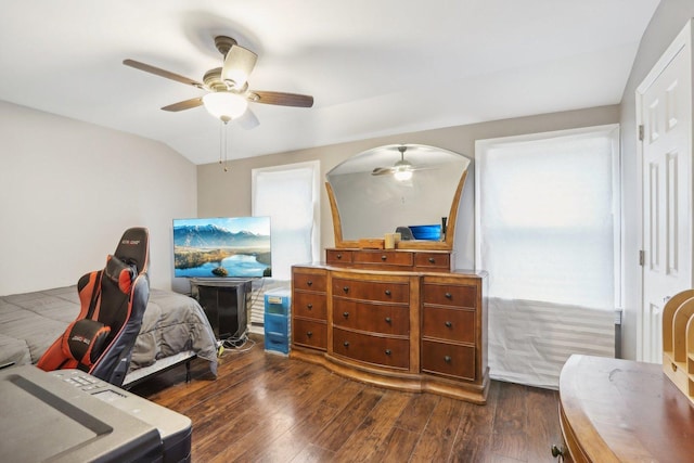 bedroom featuring ceiling fan, dark hardwood / wood-style flooring, and vaulted ceiling