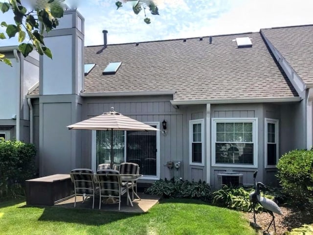 back of house with a yard and cooling unit