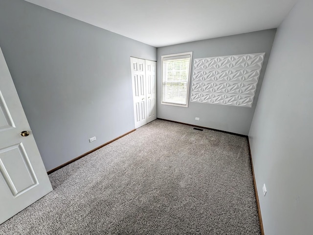 unfurnished bedroom with carpet flooring and a closet