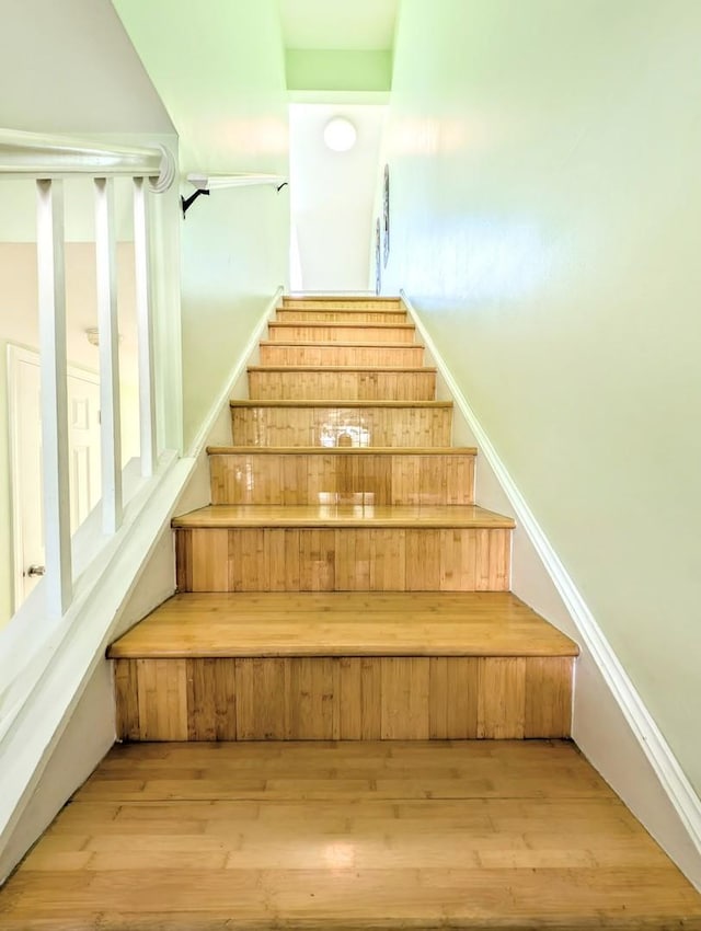 stairs with hardwood / wood-style flooring