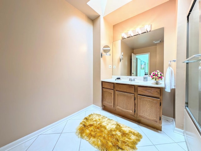 bathroom featuring shower / bath combination with glass door, tile patterned flooring, and vanity