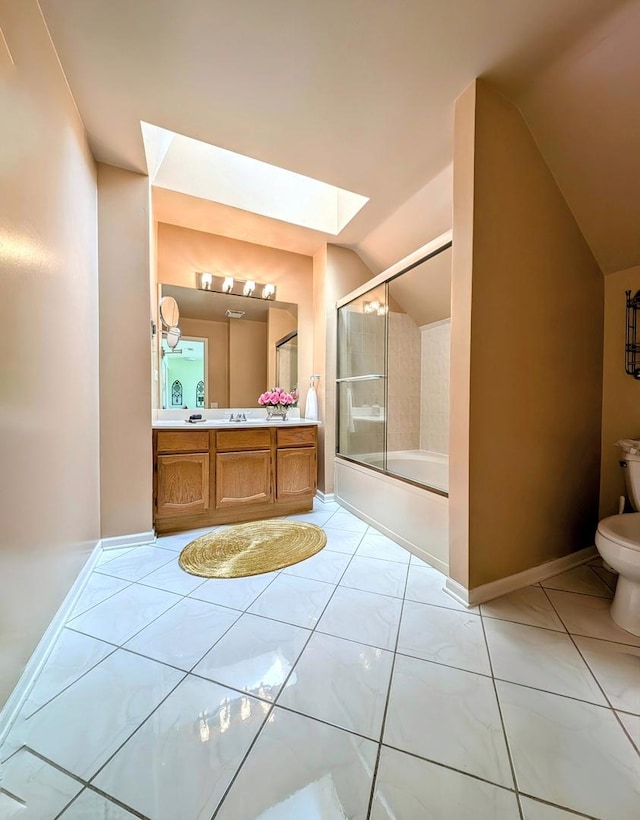 full bathroom with vanity, tile patterned floors, bath / shower combo with glass door, vaulted ceiling with skylight, and toilet