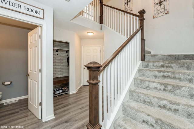 stairs with hardwood / wood-style floors