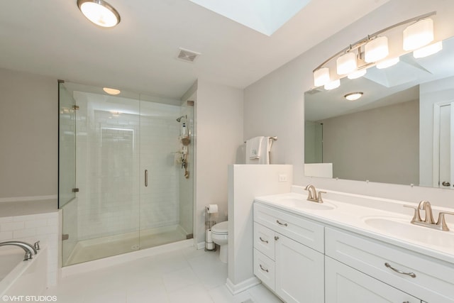 full bathroom with a skylight, toilet, vanity, and shower with separate bathtub