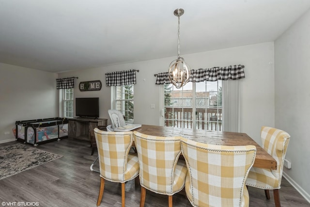 dining room with hardwood / wood-style flooring and a chandelier