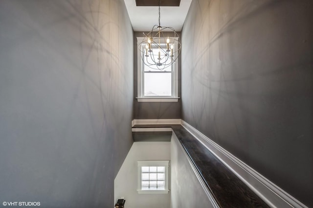 stairs featuring an inviting chandelier