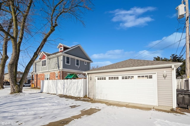 exterior space featuring a garage and an outdoor structure