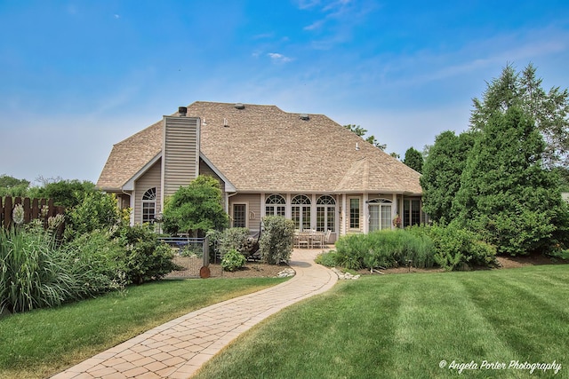 35161 N Indian Trl, Ingleside, IL 60041 - back of house with a chimney, a yard, and a shingled roof