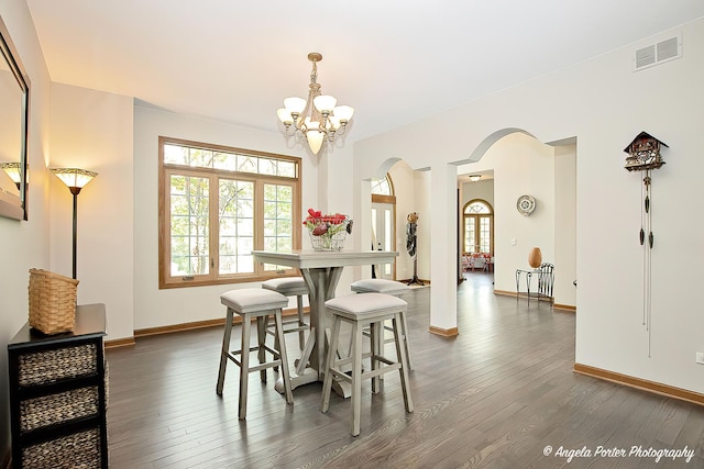 35161 N Indian Trl, Ingleside, IL 60041 - dining space featuring visible vents, dark wood finished floors, arched walkways, an inviting chandelier, and baseboards