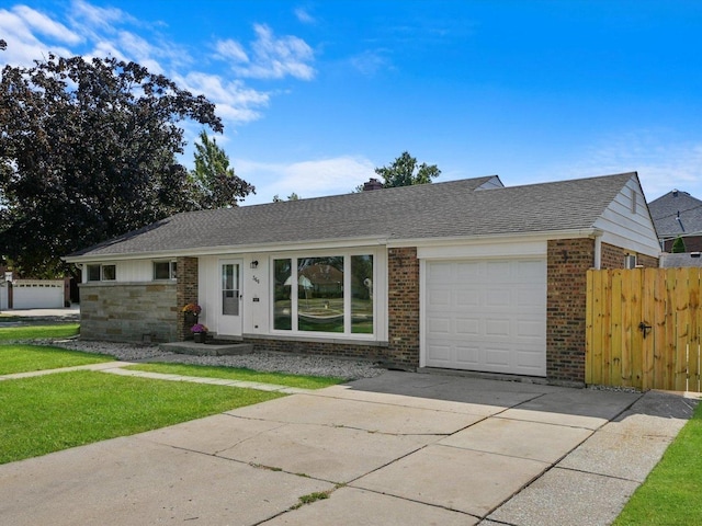 single story home featuring a garage and a front yard