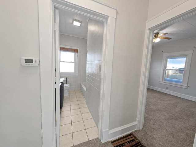 bathroom with ceiling fan, tile patterned flooring, tile walls, and toilet