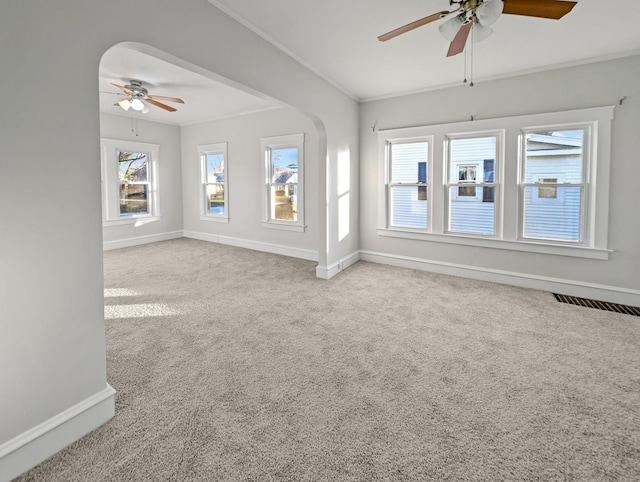 unfurnished living room with ceiling fan, light colored carpet, and crown molding