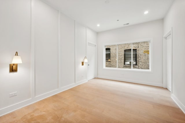 unfurnished room with light hardwood / wood-style flooring