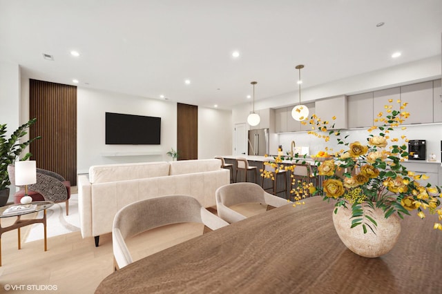 dining area with light hardwood / wood-style floors