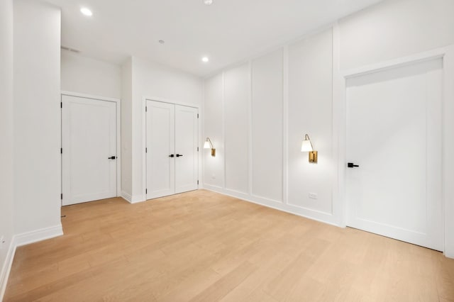 empty room with light hardwood / wood-style flooring