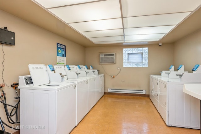 laundry room with a wall mounted air conditioner, a baseboard radiator, and washing machine and clothes dryer