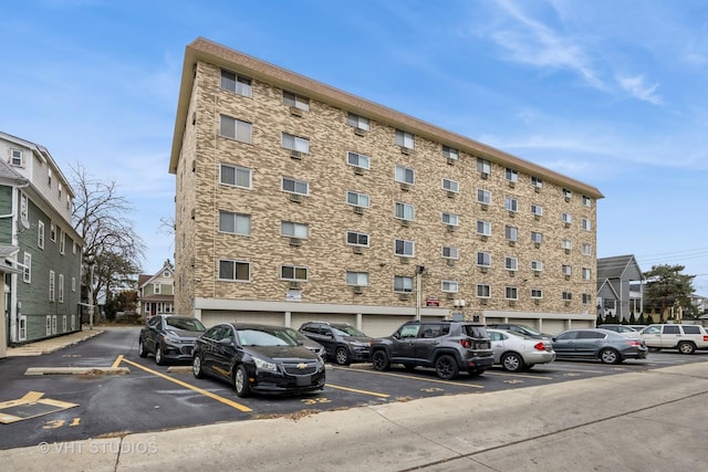 view of building exterior featuring uncovered parking