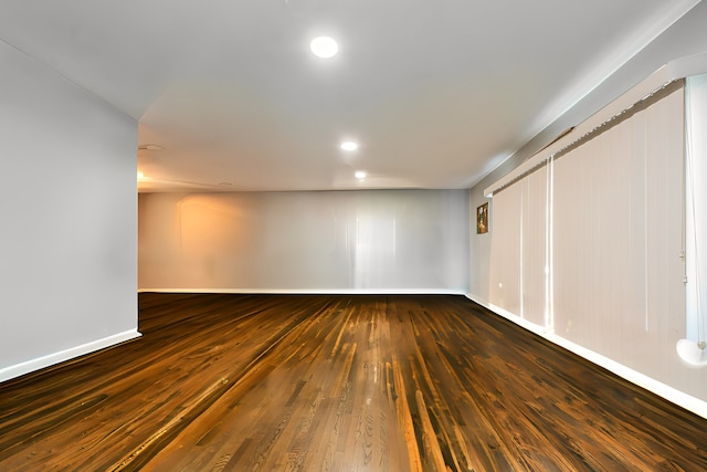 empty room with dark hardwood / wood-style floors