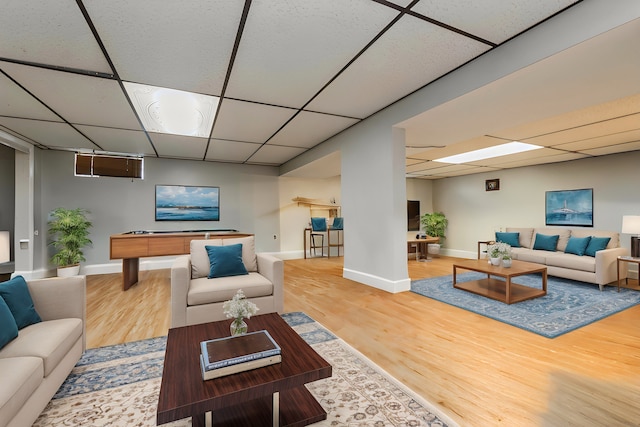 living room with hardwood / wood-style flooring, a drop ceiling, and billiards