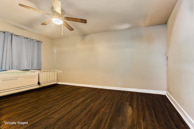 unfurnished room with ceiling fan and dark hardwood / wood-style floors