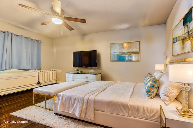 bedroom with dark hardwood / wood-style flooring and ceiling fan