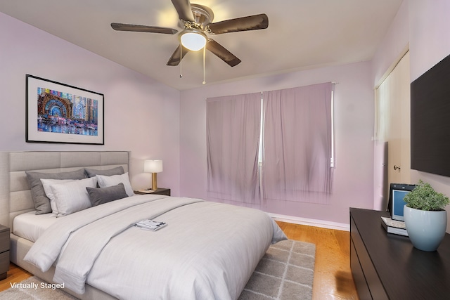 bedroom featuring light hardwood / wood-style flooring and ceiling fan