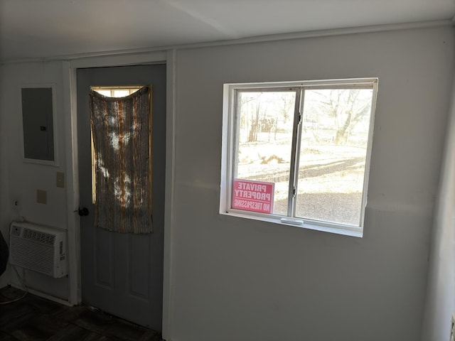 foyer featuring electric panel and a wall unit AC