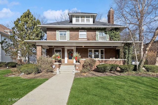 view of front of house with a front yard and covered porch