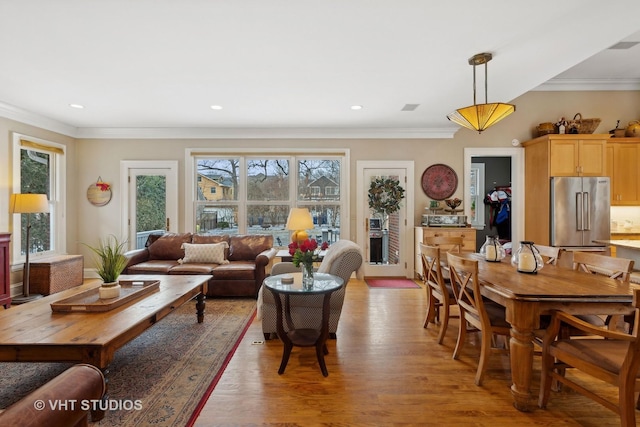 living room featuring light hardwood / wood-style flooring and ornamental molding