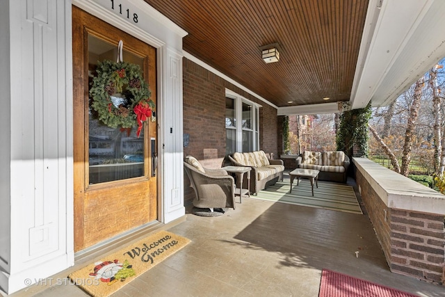 wooden terrace featuring covered porch