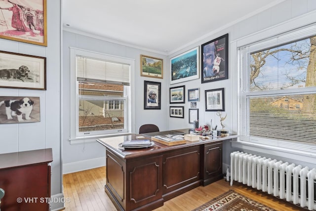 office area with ornamental molding, radiator, and light hardwood / wood-style floors