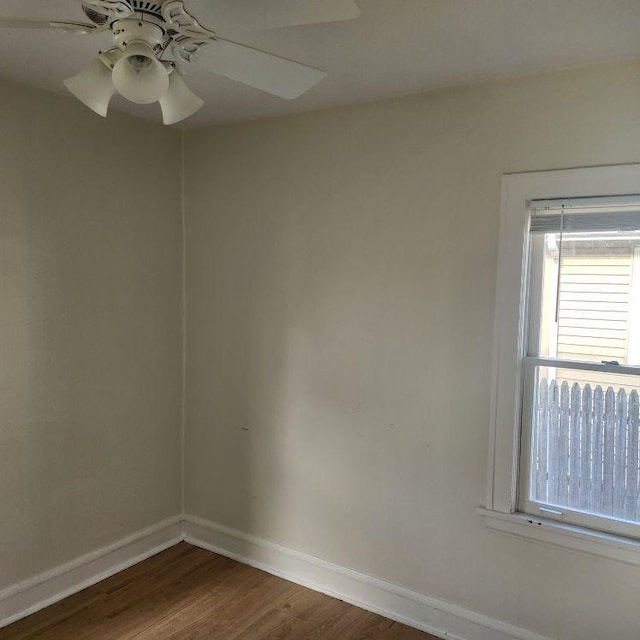 spare room with hardwood / wood-style flooring and ceiling fan