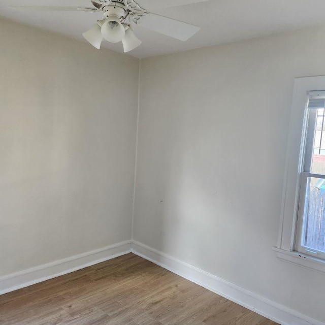 empty room with hardwood / wood-style flooring and ceiling fan