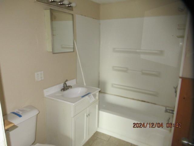 full bathroom featuring tile patterned floors, vanity, toilet, and shower / tub combination