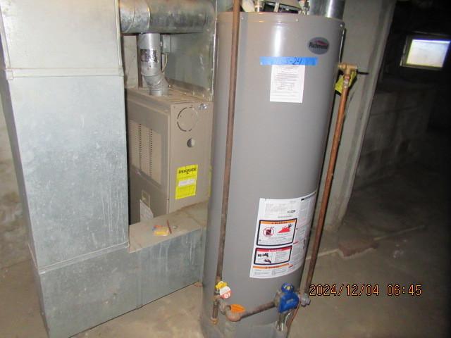 utility room with gas water heater