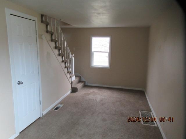 basement featuring light colored carpet