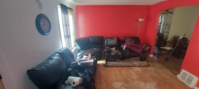 living room featuring ceiling fan and wood-type flooring