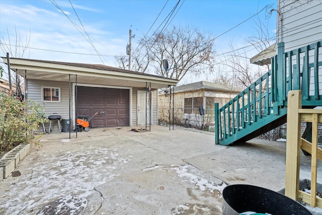 view of patio / terrace with a garage and an outdoor structure