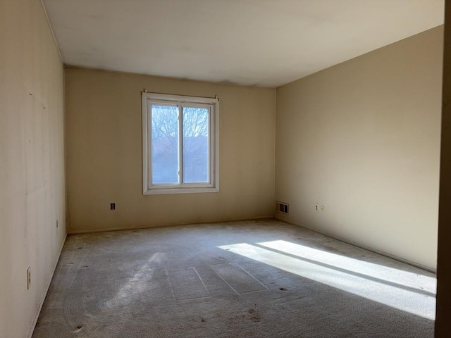 empty room with visible vents and carpet floors