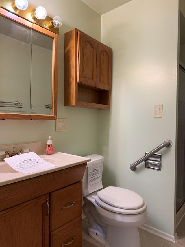 full bathroom with toilet, tile patterned flooring, baseboards, walk in shower, and vanity