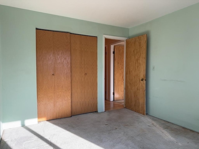 unfurnished bedroom featuring a closet and carpet