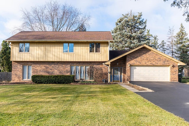 view of front of home with a garage and a front lawn